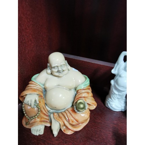 513 - A quantity of Buddhas of varying sizes including a tealight Buddha, a jade Buddha on stand, resins B... 