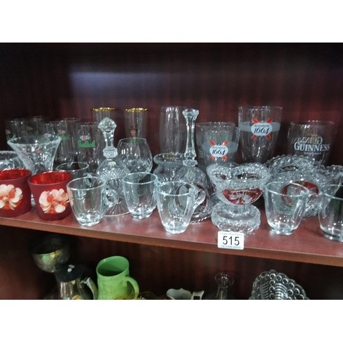515 - a large quantity of glassware including five Grolsch lager glasses, Kronenbourg, Guinness and an orn... 