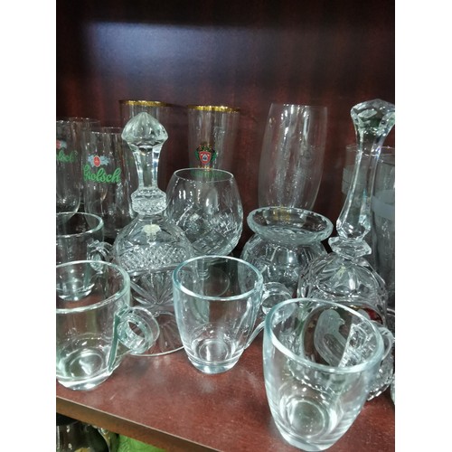 515 - a large quantity of glassware including five Grolsch lager glasses, Kronenbourg, Guinness and an orn... 