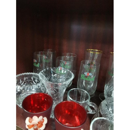 515 - a large quantity of glassware including five Grolsch lager glasses, Kronenbourg, Guinness and an orn... 
