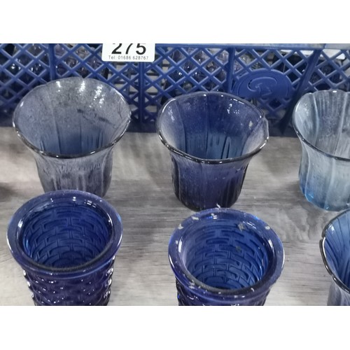 275 - A quantity of 32 blue glass tea lights with various designs.