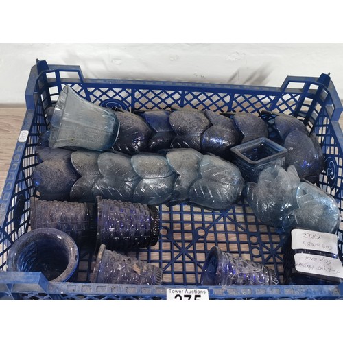 275 - A quantity of 32 blue glass tea lights with various designs.