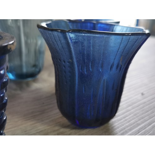 275 - A quantity of 32 blue glass tea lights with various designs.