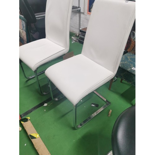 526 - A pair of white leatherette dining chairs with single chrome legs in very good clean order.
Height 1... 