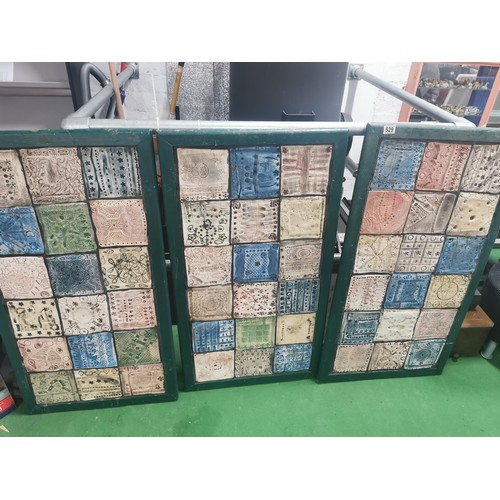 529 - Three wooden panels of naive tile art, each panel containing eighteen handmade, hand decorated tiles... 
