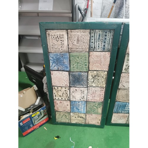 529 - Three wooden panels of naive tile art, each panel containing eighteen handmade, hand decorated tiles... 
