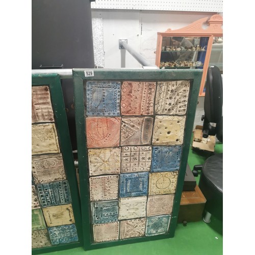 529 - Three wooden panels of naive tile art, each panel containing eighteen handmade, hand decorated tiles... 