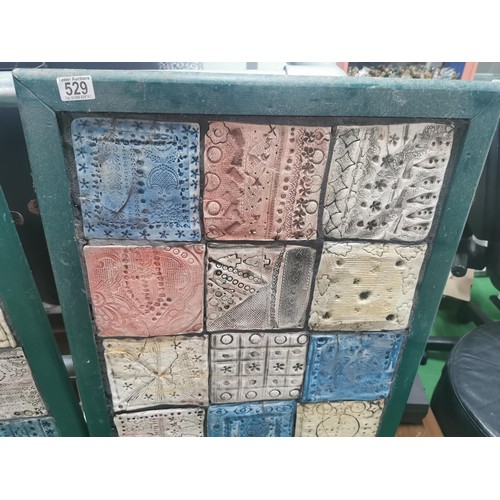 529 - Three wooden panels of naive tile art, each panel containing eighteen handmade, hand decorated tiles... 