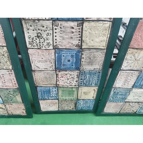 529 - Three wooden panels of naive tile art, each panel containing eighteen handmade, hand decorated tiles... 