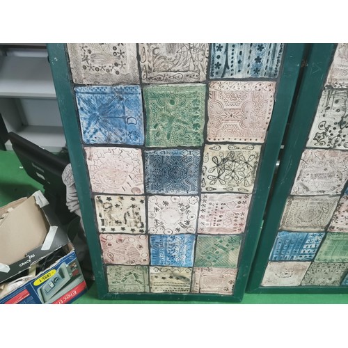 529 - Three wooden panels of naive tile art, each panel containing eighteen handmade, hand decorated tiles... 