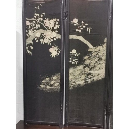531 - An antique Asian ebonised 4 fold double sided embroidered silk screen. One side decorated with a pea... 