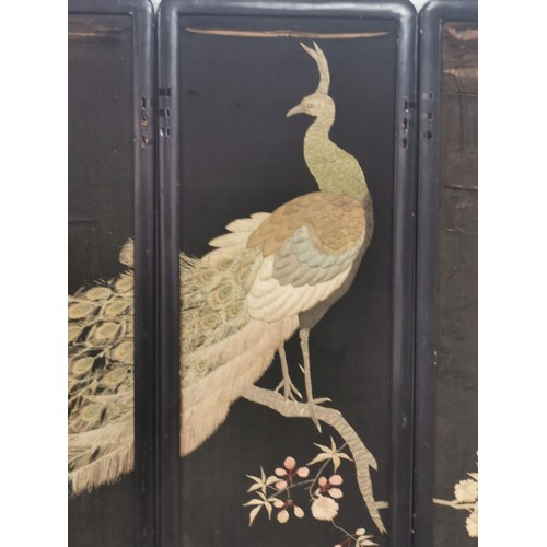 531 - An antique Asian ebonised 4 fold double sided embroidered silk screen. One side decorated with a pea... 