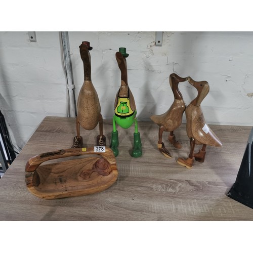 278 - A selection of fair trade items including two booted duck figures, a pair of love ducks, a tall flam... 