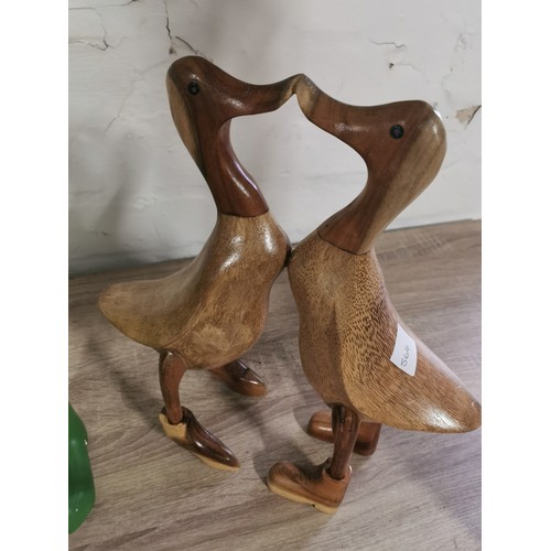 278 - A selection of fair trade items including two booted duck figures, a pair of love ducks, a tall flam... 