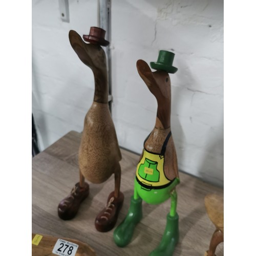 278 - A selection of fair trade items including two booted duck figures, a pair of love ducks, a tall flam... 