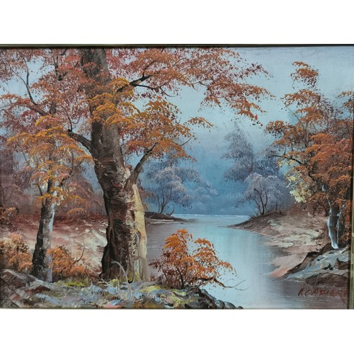 289 - A pair of framed oil paintings of woodland and river scenes. Commercial paintings. Largest measure h... 