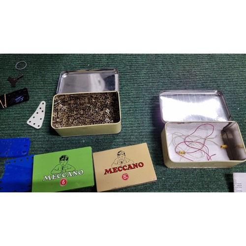 10 - Large quantity of various vintage Meccano parts and accessories most are organised into metal tinds ... 