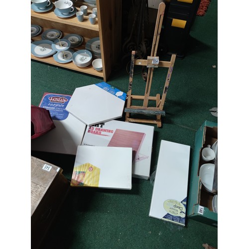 534 - A large quantity of artists equipment including , a quantity of stretched canvases, drawing board et... 