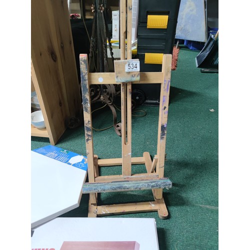 534 - A large quantity of artists equipment including , a quantity of stretched canvases, drawing board et... 