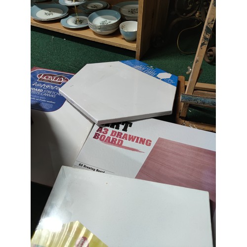 534 - A large quantity of artists equipment including , a quantity of stretched canvases, drawing board et... 