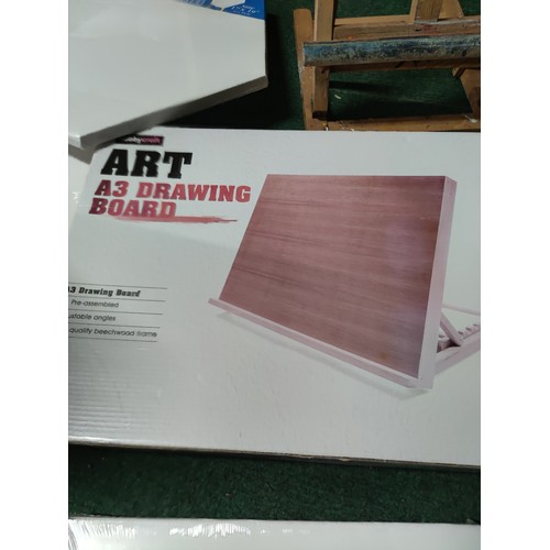 534 - A large quantity of artists equipment including , a quantity of stretched canvases, drawing board et... 