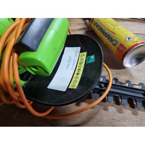 24 - Macallister cordless battery powered strimmer complete with battery and charger - working along with... 