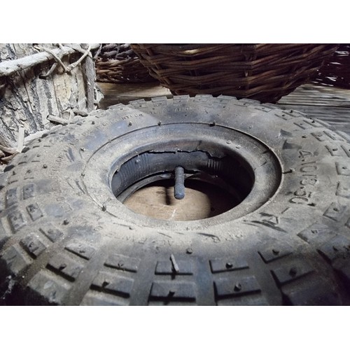 39 - Large quantity of various wicker baskets along with a hand made wooden basket and a wheelbarrow tyre... 