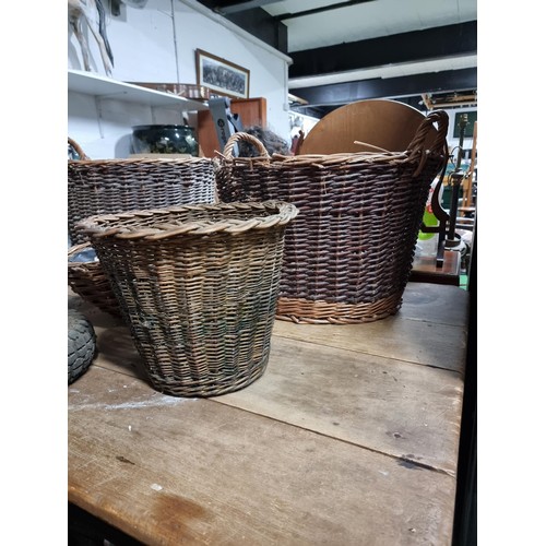 39 - Large quantity of various wicker baskets along with a hand made wooden basket and a wheelbarrow tyre... 