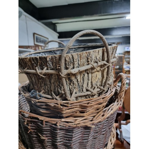 39 - Large quantity of various wicker baskets along with a hand made wooden basket and a wheelbarrow tyre... 