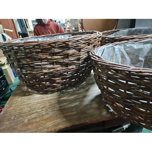 40 - 3x large wicker basket planters, all with plastic lining. Largest basket measures 30cm height x diam... 