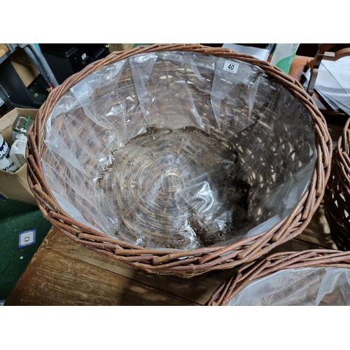 40 - 3x large wicker basket planters, all with plastic lining. Largest basket measures 30cm height x diam... 