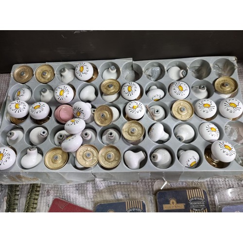 75 - 2x boxes full of various ceramic door and drawer knobs with various designs along with a large quant... 