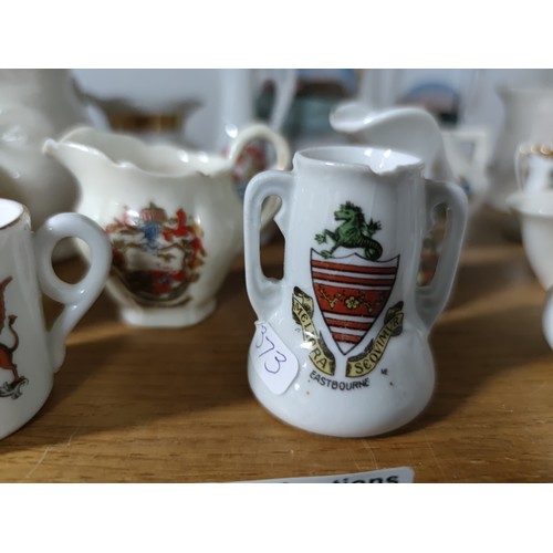 453 - A collection of 33 collectable crestware pieces including a model of Mary Queen of Scots  chair, vas... 