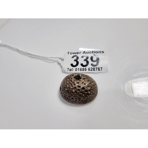 339 - An unusual lump of solid silver with an impressed square stamp appearing to have Asian character mar... 