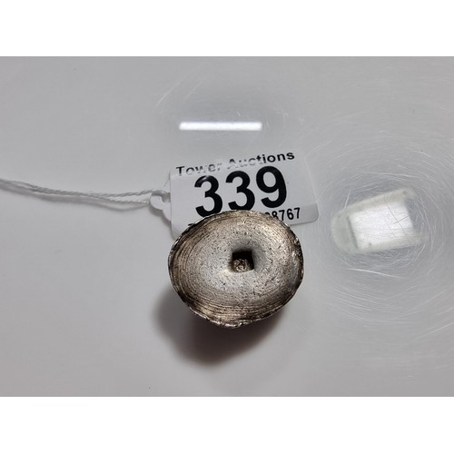 339 - An unusual lump of solid silver with an impressed square stamp appearing to have Asian character mar... 