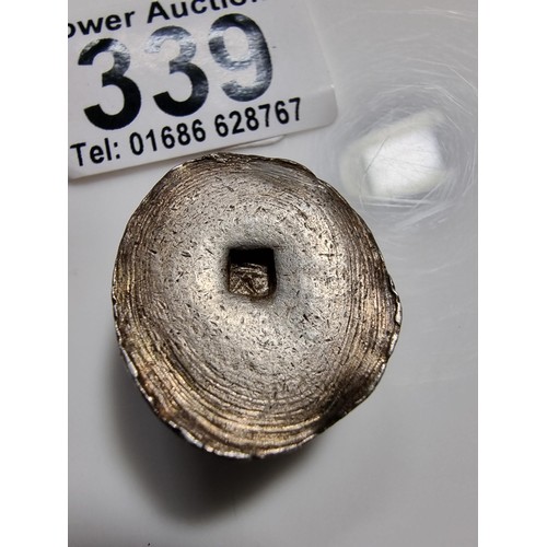 339 - An unusual lump of solid silver with an impressed square stamp appearing to have Asian character mar... 