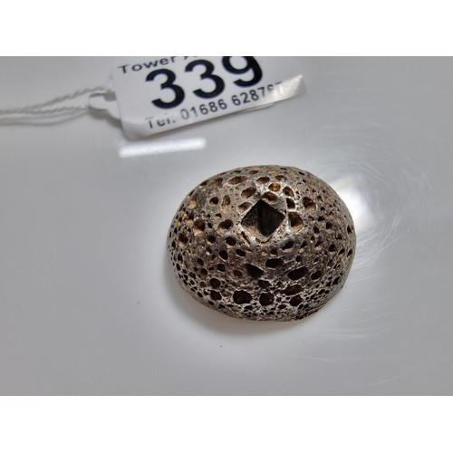 339 - An unusual lump of solid silver with an impressed square stamp appearing to have Asian character mar... 