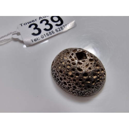 339 - An unusual lump of solid silver with an impressed square stamp appearing to have Asian character mar... 
