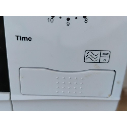 124 - A 700w dial microwave, along with a 2 slice toaster.