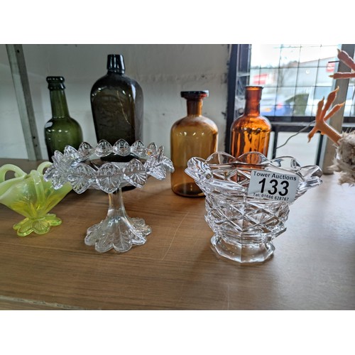 133 - A quantity of vintage glassware including coloured beer bottles, poison bottles along with 2 Sunderl... 