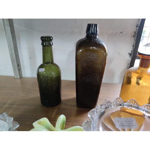 133 - A quantity of vintage glassware including coloured beer bottles, poison bottles along with 2 Sunderl... 