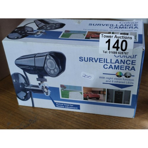 140 - A boxed colour surveillance camera,along with 2 large bubbled paperweights.