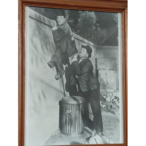 157 - A pair of framed and glazed Laurel and Hardy black and white photos, both in excellent condition. He... 