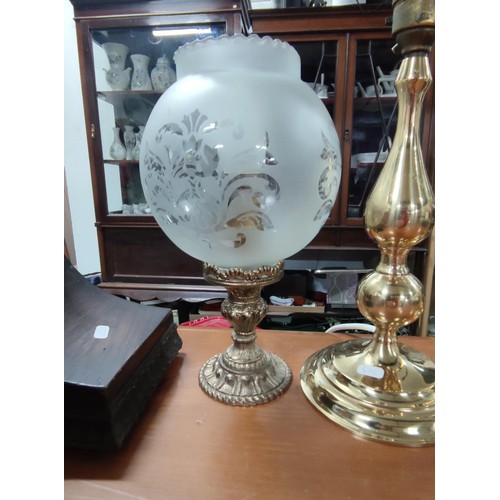 198 - A collection of 4 brass lamps, one with a glass etched shade.
Tallest one has height of 38cm.