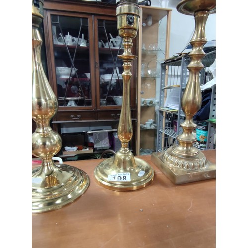 198 - A collection of 4 brass lamps, one with a glass etched shade.
Tallest one has height of 38cm.