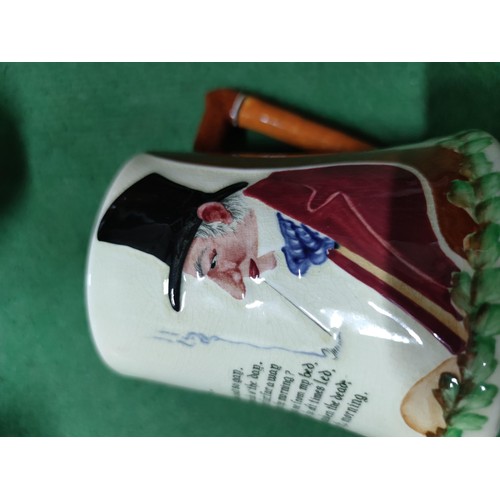 303 - A box containing an assortment of collectables including a John Peel tankard, a vintage aqua bottle,... 