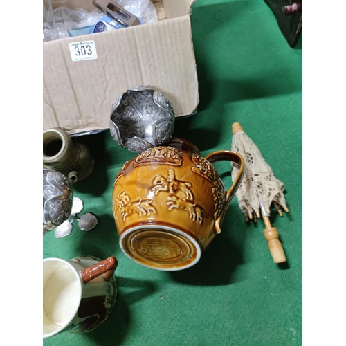 303 - A box containing an assortment of collectables including a John Peel tankard, a vintage aqua bottle,... 