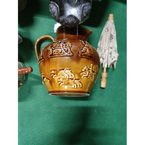 303 - A box containing an assortment of collectables including a John Peel tankard, a vintage aqua bottle,... 