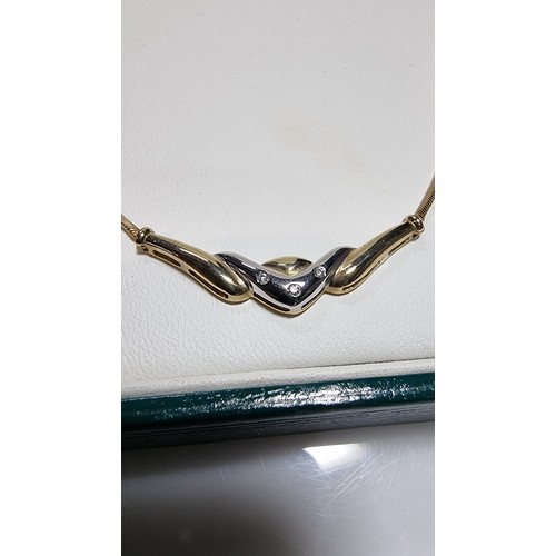 423 - Hallmarked 9ct yellow gold necklace with a two tone yellow and white gold pendant inset with three s... 