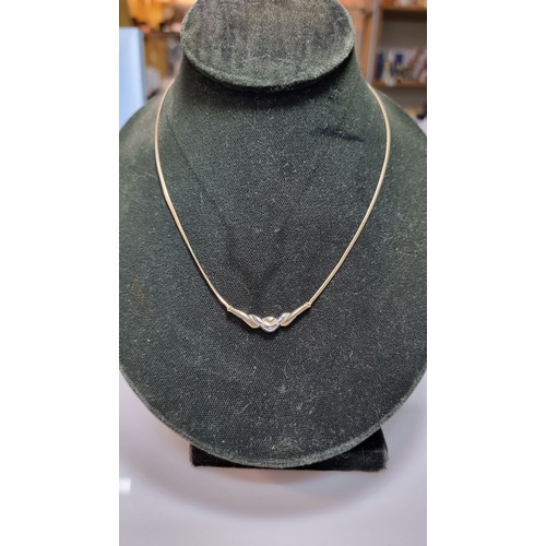 423 - Hallmarked 9ct yellow gold necklace with a two tone yellow and white gold pendant inset with three s... 